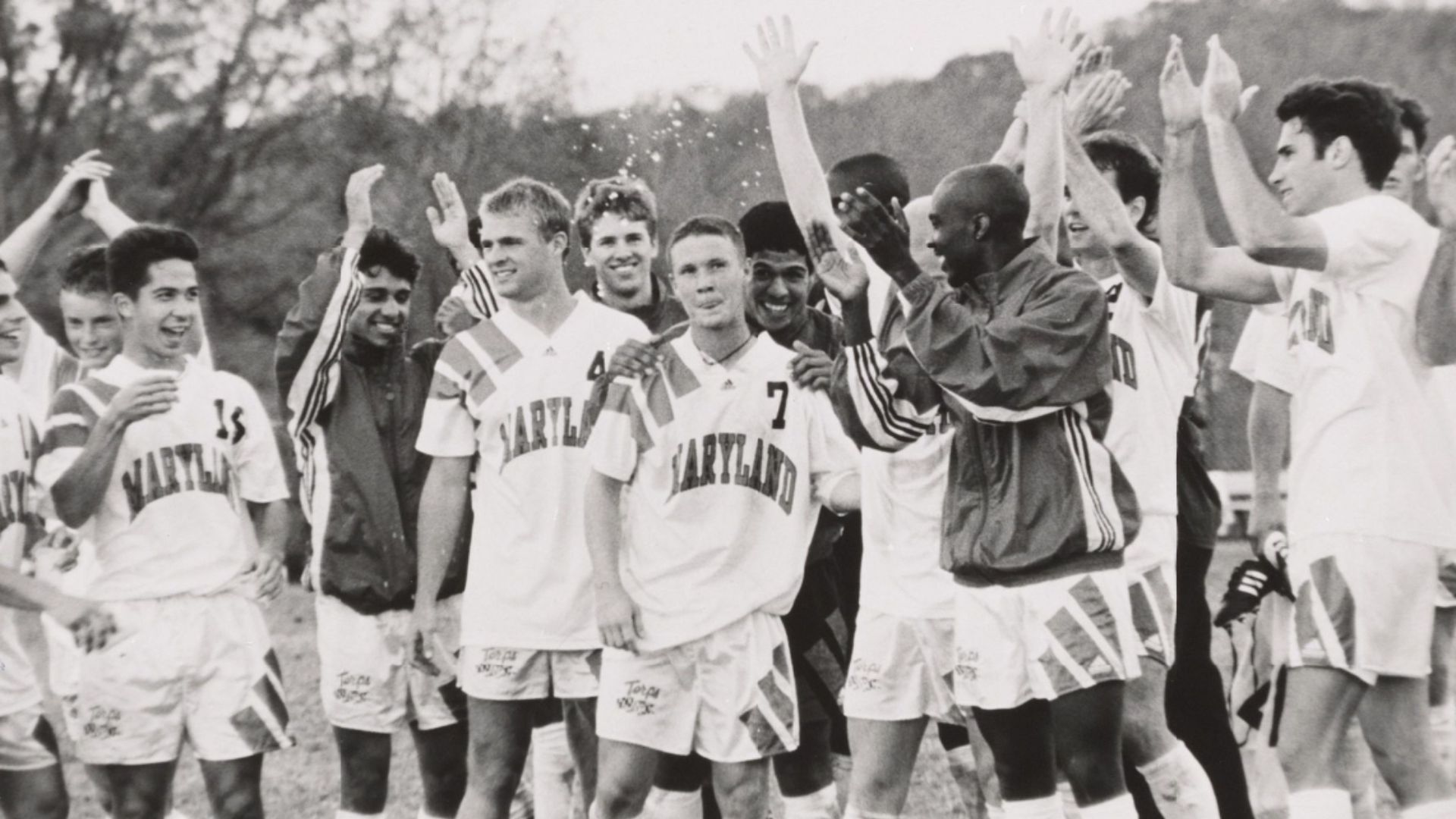 UMD men's soccer players celebrate