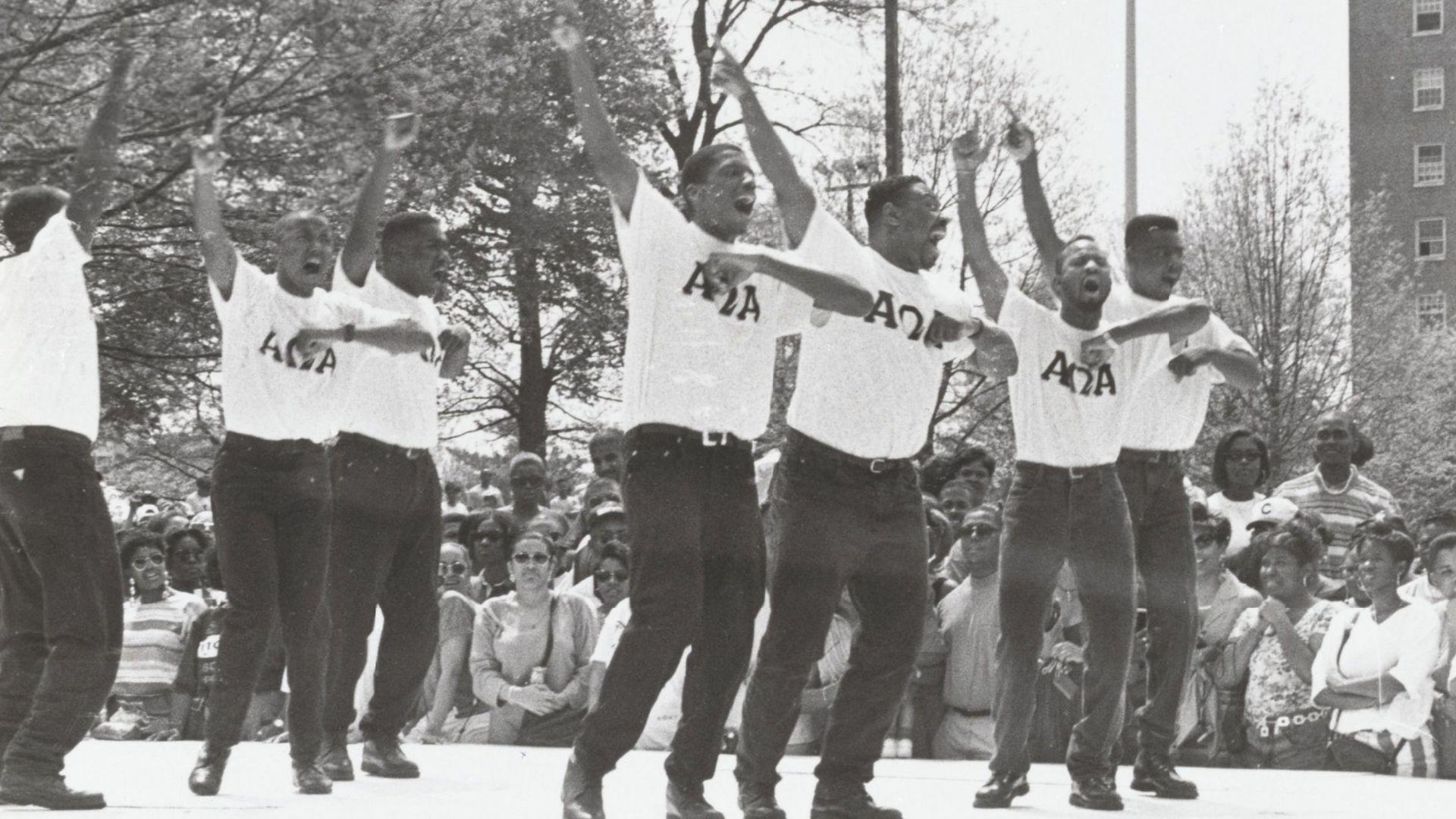 Black Frat Block Party at La Plata Beach; male students in Alpha Omega Alpha shirts step dance for a crowd of onlookers