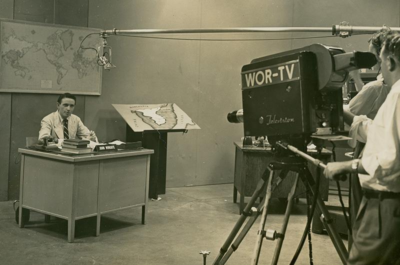 Reporter for WOR-TV being filmed at a desk