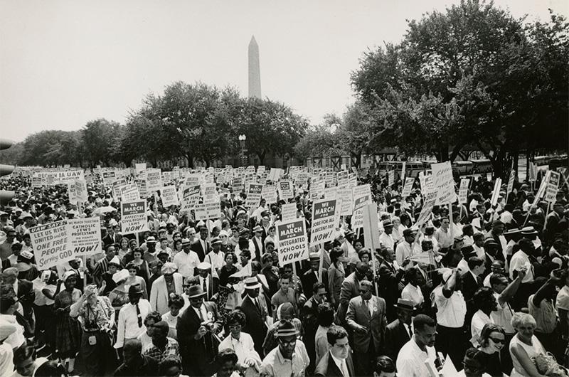 Crowd of protesters from the 1963 March on Washington with the Washington Monument in the background