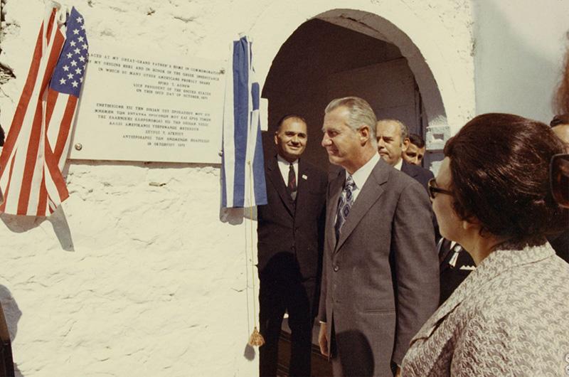 Spiro Agnew reads a plaque on a white wall in Gargalianoi